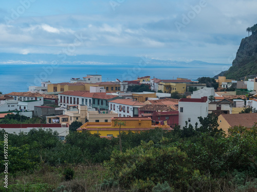 View of old village Agulo with colorful traditional houses, terraced fields and ocean in green valley at north coast. Cloudy winter day. La Gomera, Canary Islands, Spain © Kristyna