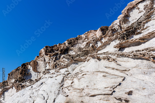 unusual rock formations of the volcanic cliff on Cala Sapone beach, quartz-trachitic ignimbrites.