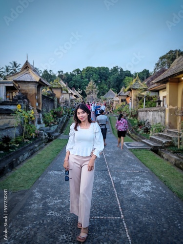  A woman smiling happily at a tourist spot © AriesBuana