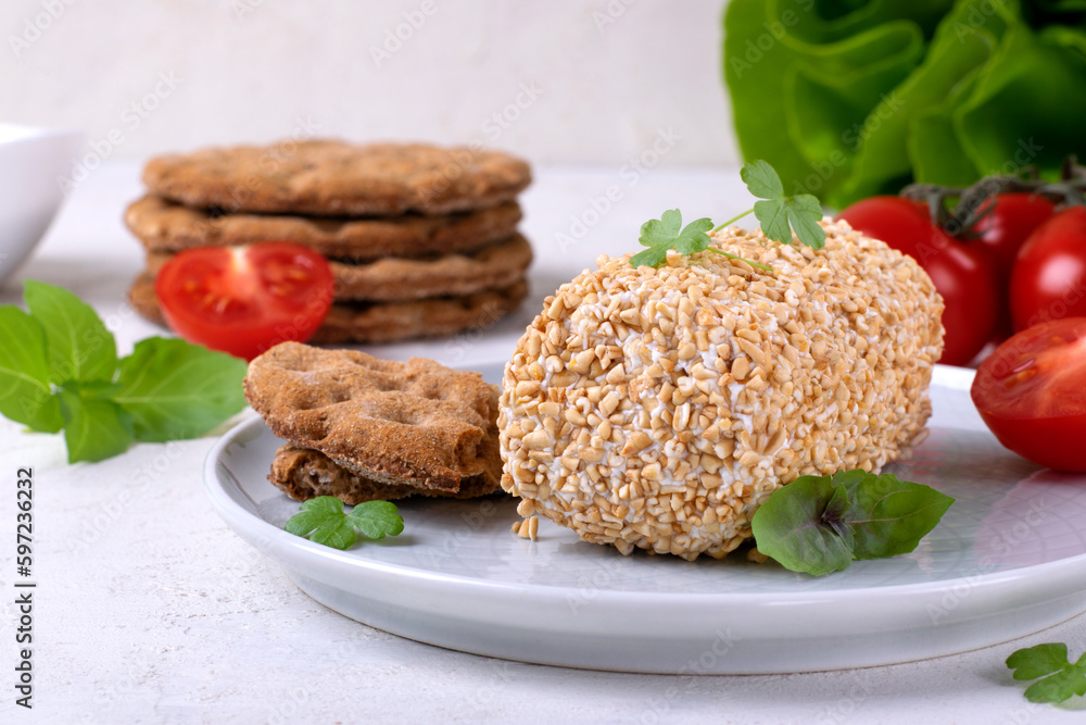 Caboc, Scottish soft cheese made of fat milk, in oat grains served on the plate Caboc, Scottish soft cheese made of fat milk, in oat grains served on the plate