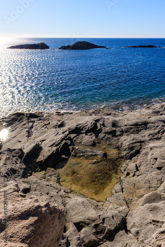 unusual rock formations of the volcanic cliff on Cala Sapone beach, quartz-trachitic ignimbrites. photo