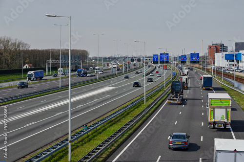 Rotterdam, The Netherlands, April 5, 2023: view from a viaduct towards the A15 motorway with traffic on a total of 14 lanes © Frans