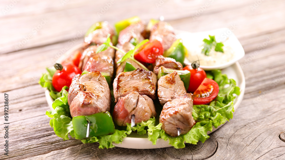 grilled beef skewer, sauce and salad grilled beef skewer, sauce and salad