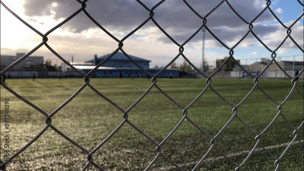 soccer field through mesh that surrounds it. Training soccer. soccer field through mesh that surrounds it. Training soccer.