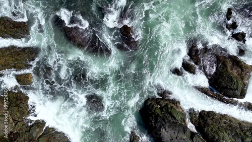 Drone video of water crashing against the coast and cliffs