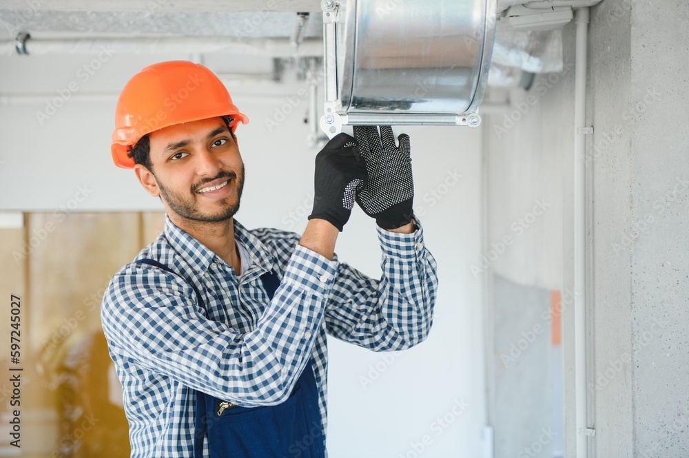 hvac indian worker install ducted pipe system for ventilation and air conditioning. copy space hvac indian worker install ducted pipe system for ventilation and air conditioning. copy space