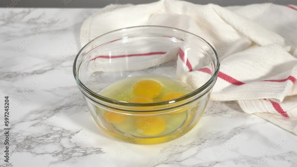Step by step. Mixing ingredients in a glass mixing bowl to prepare bacon and cheese egg muffin. Step by step. Mixing ingredients in a glass mixing bowl to prepare bacon and cheese egg muffin.