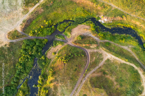 aerial view of the forest summer landscape, the road crosses the river
