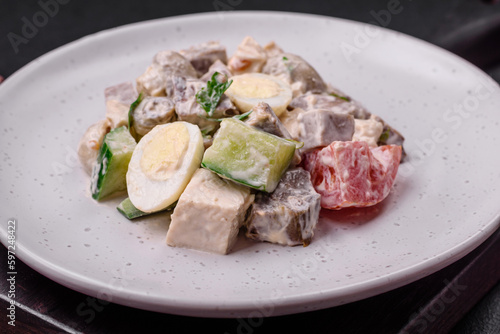 Delicious salad with boiled beef tongue, quail eggs, tomatoes and cucumber