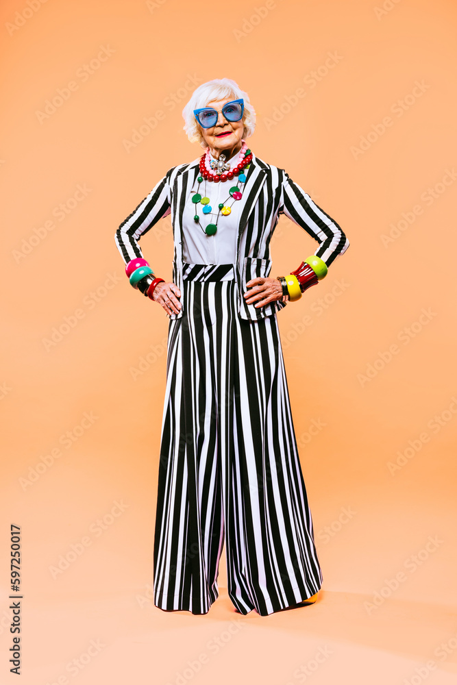 Cool and stylish senior old woman with fashionable clothes - Elderly funny female with stylish colorful dress portrait on isolated colored background Cool and stylish senior old woman with fashionable clothes - Elderly funny female with stylish colorful dress portrait on isolated colored background