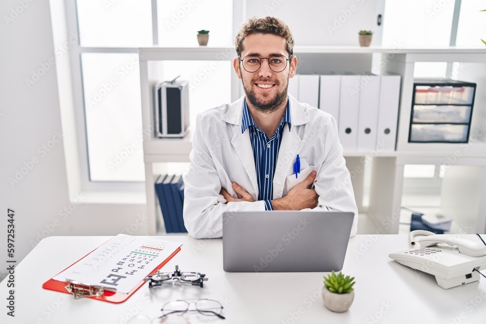 Hispanic man with beard wearing doctor uniform and stethoscope happy face smiling with crossed arms looking at the camera. positive person. Hispanic man with beard wearing doctor uniform and stethoscope happy face smiling with crossed arms looking at the camera. positive person.