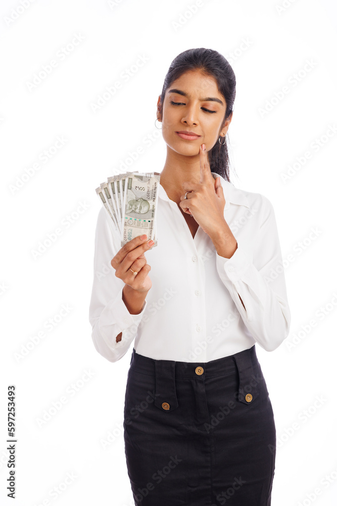 Business woman thinking with Indian currency isolated on white. Business woman thinking with Indian currency isolated on white.