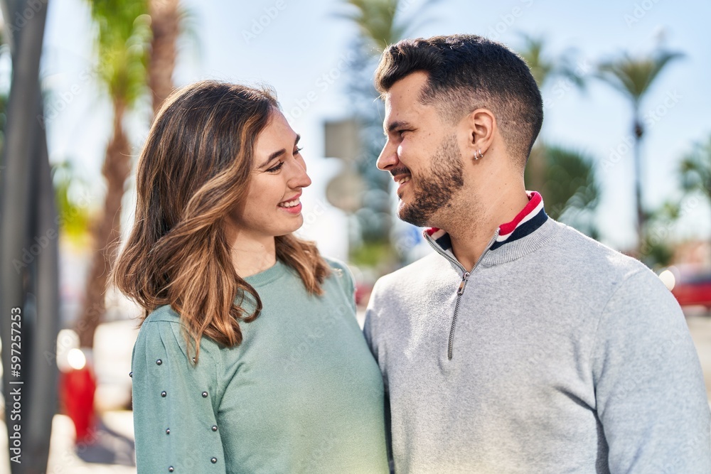 Obraz premium Man and woman smiling confident hugging each other standing at street