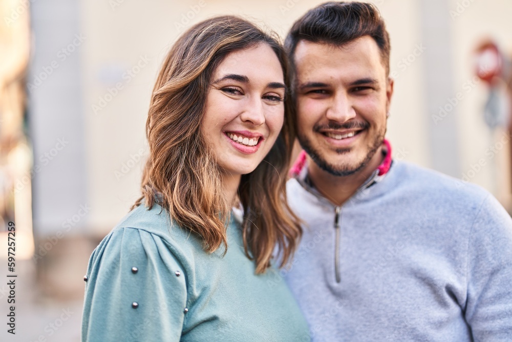 Man and woman smiling confident standing together at street Man and woman smiling confident standing together at street