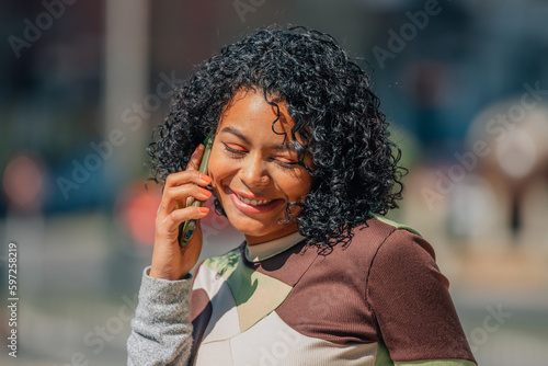 urban girl on the street with mobile phone