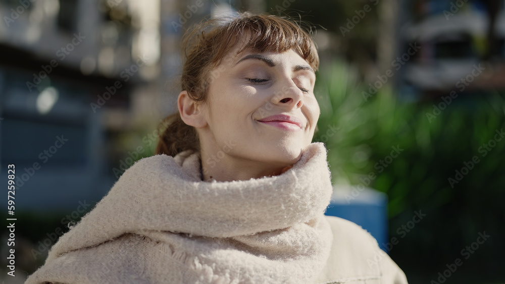 Young caucasian woman smiling confident with closed eyes enjoying sunlight at park Young caucasian woman smiling confident with closed eyes enjoying sunlight at park
