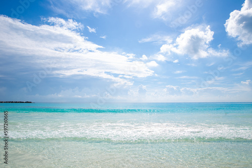 Beautiful sandy beach with people relaxing in a resort in Cancun, Mexico. Summer and sunshine.