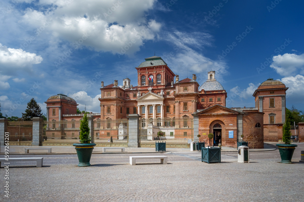 Racconigi, Cuneo, Piedmont, Italy - April 27, 2023: Royal Castle of Racconigi residence of the Savoy family since the 14th century, landscape with blue sky and white clouds