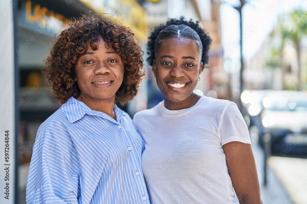 African american women mother and daughter standing together at street African american women mother and daughter standing together at street