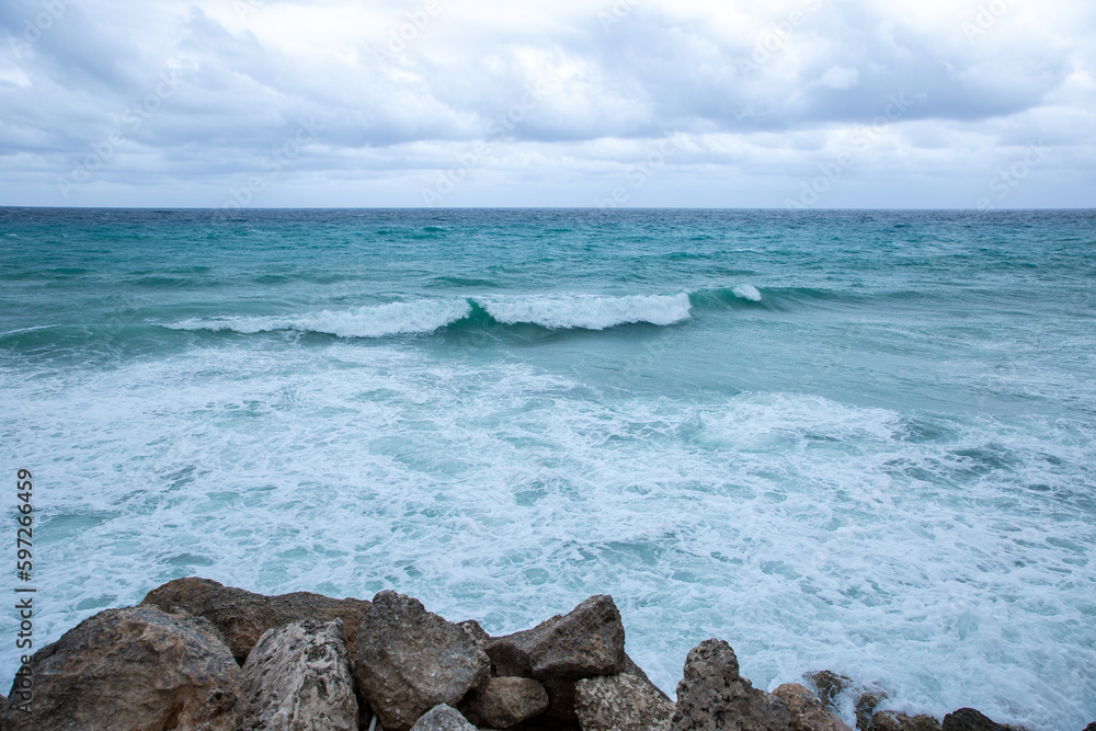 Tropical storm in the Atlantic Ocean. Beautiful rocky shore with rolling waves. Hurricane in Caribbean Sea, Gulf of Mexico, Cancun.