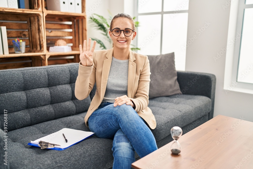 Young woman working at consultation office showing and pointing up with fingers number four while smiling confident and happy. Young woman working at consultation office showing and pointing up with fingers number four while smiling confident and happy.