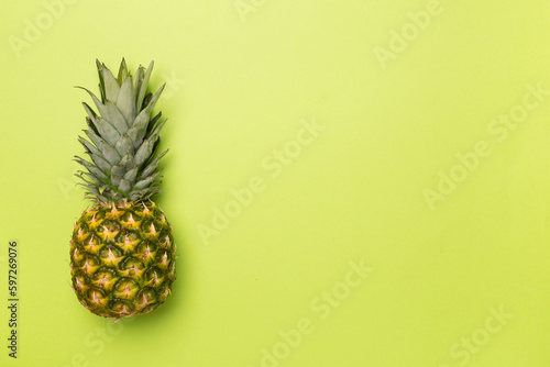 Fresh pineapple on color background, top view