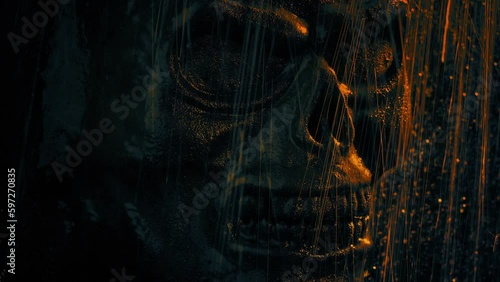 Skull Face On Temple Wall In Firelight And Rain