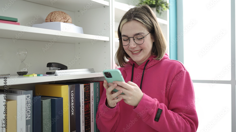 Young blonde woman student smiling confident using smartphone at library university Young blonde woman student smiling confident using smartphone at library university