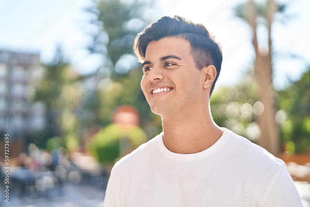 Fototapeta premium Young hispanic man smiling confident looking to the side at street