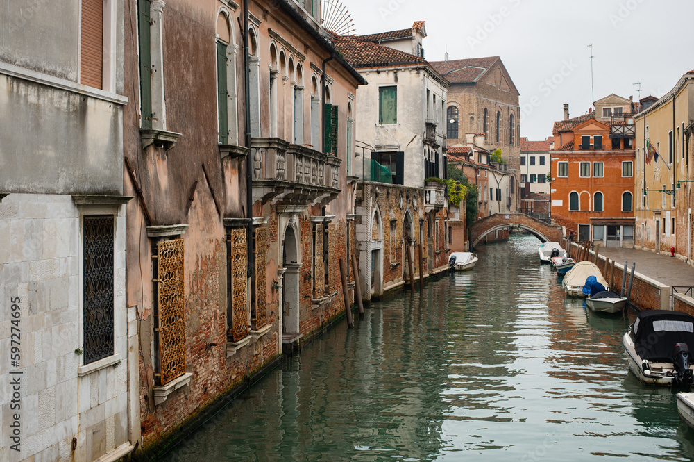 Cozy narrow canals of Venice city with old traditional architecture, bridges and boats, Veneto, Italy. Tourism concept. Architecture and landmark of Venice. Cozy cityscape of Venice.