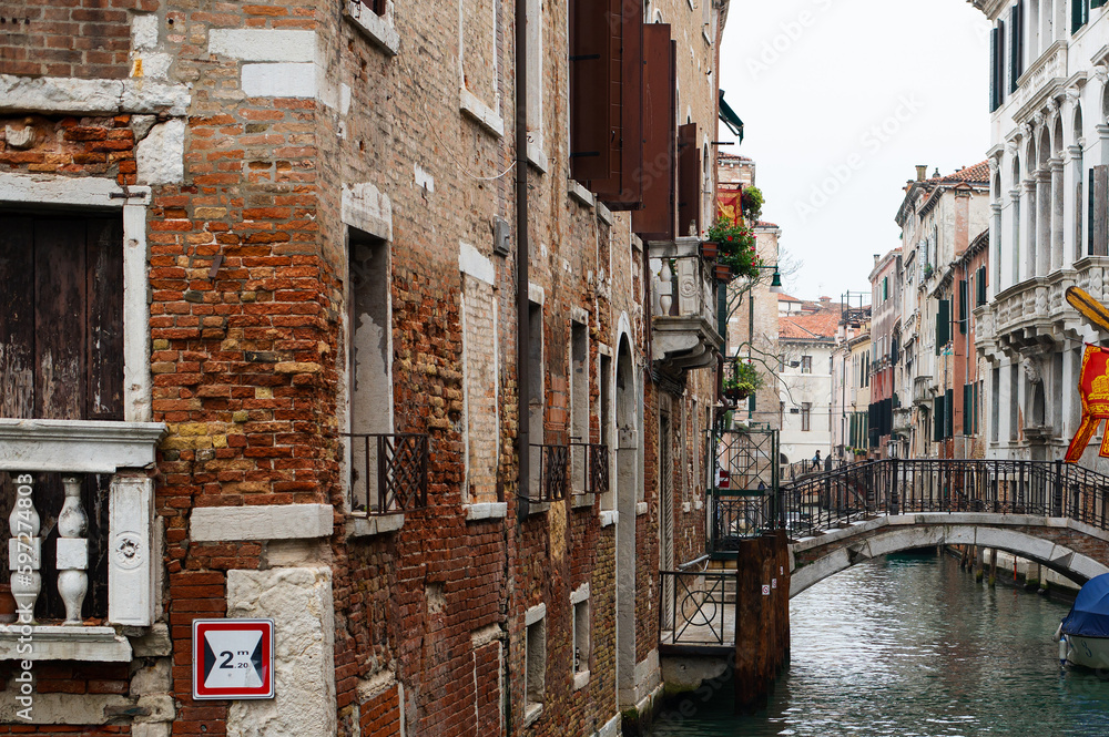 Cozy narrow canals of Venice city with old traditional architecture, bridges and boats, Veneto, Italy. Tourism concept. Architecture and landmark of Venice. Cozy cityscape of Venice.