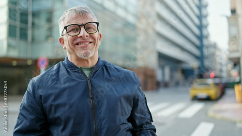 Middle age grey-haired man smiling confident standing at street © Krakenimages.com