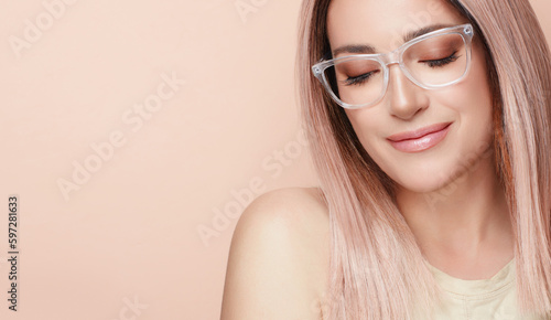 Woman in fashionable clear glasses posing in studio. Fashion eyewear and clear vision concept