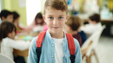 Adorable caucasian boy student smiling confident standing at classroom