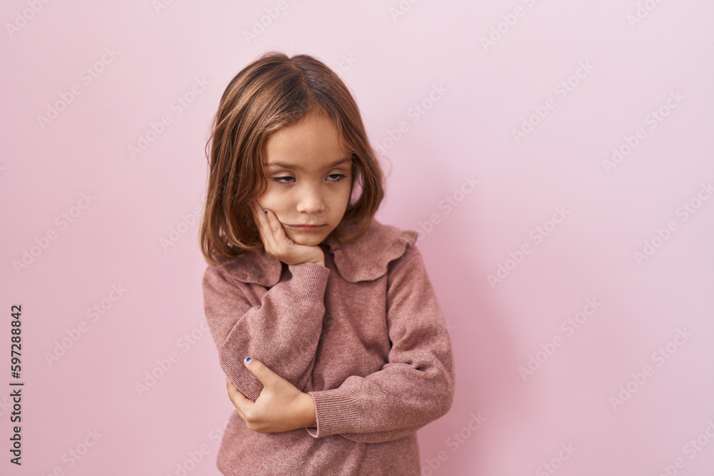 Little hispanic girl standing over pink background thinking looking tired and bored with depression problems with crossed arms. Little hispanic girl standing over pink background thinking looking tired and bored with depression problems with crossed arms.