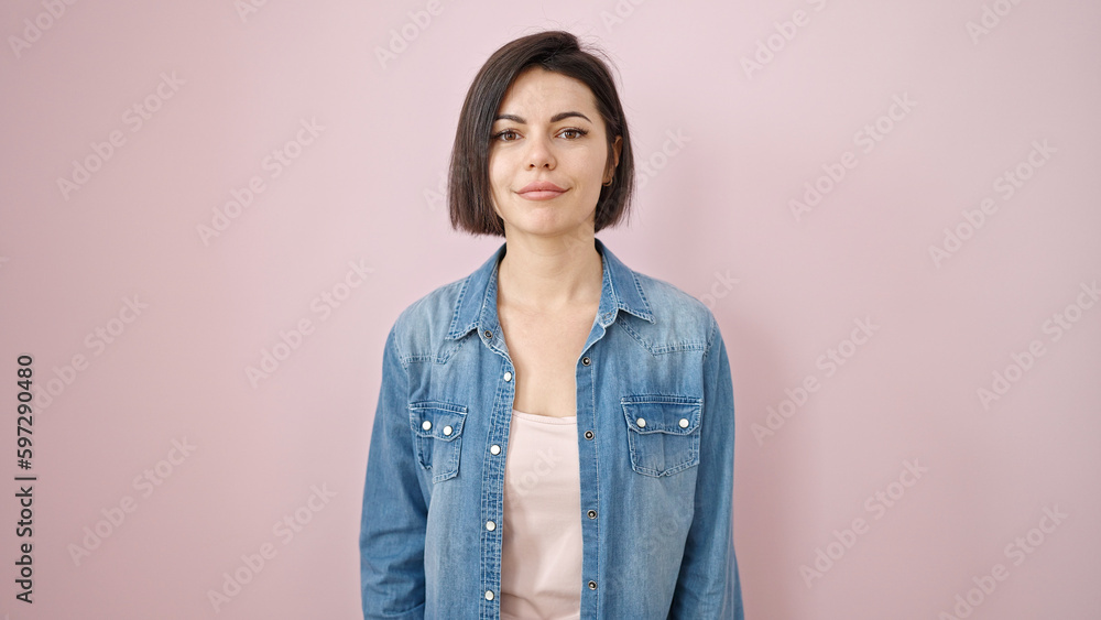 Young caucasian woman standing with serious expression over isolated pink background Young caucasian woman standing with serious expression over isolated pink background