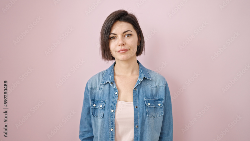 Fototapeta premium Young caucasian woman smiling confident over isolated pink background