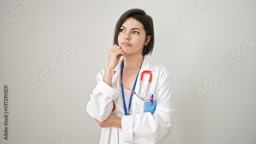 Young caucasian woman doctor standing with doubt expression thinking over isolated white background