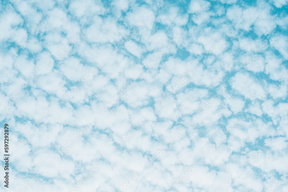 Blue skies with white clouds background with space for text, blue cloudy skies texture. 