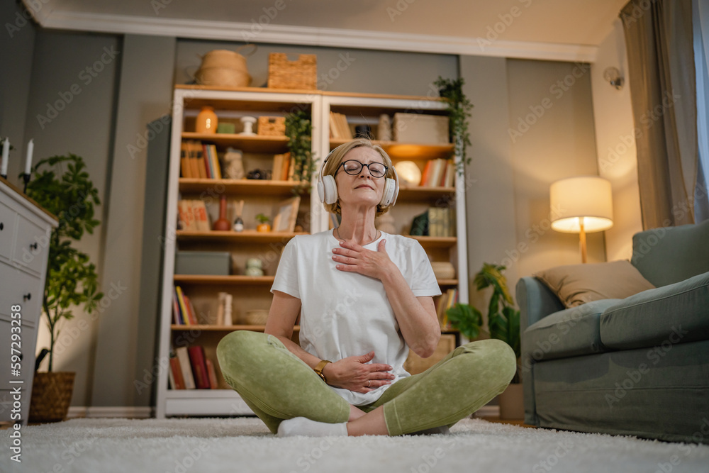 Mature senior woman practice guided meditation manifestation at home Mature senior woman practice guided meditation manifestation at home
