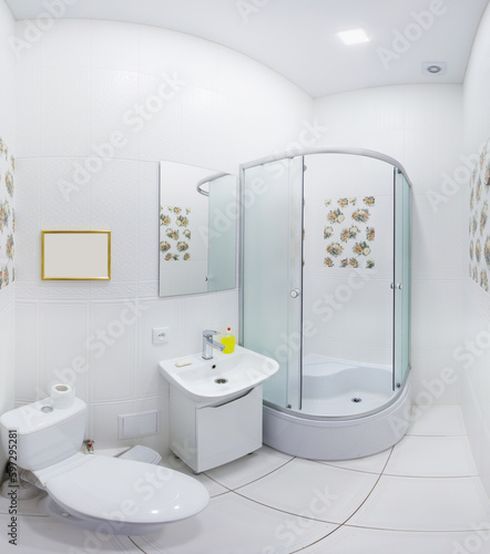 Panoramic photo of a white bathroom with shower.
