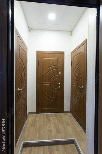 Entrance to an apartment building with 3 doors.