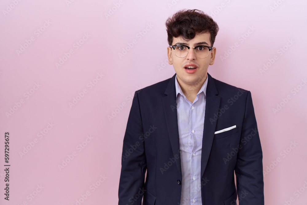 Young non binary man with beard wearing suit and tie afraid and shocked with surprise expression, fear and excited face. Young non binary man with beard wearing suit and tie afraid and shocked with surprise expression, fear and excited face.