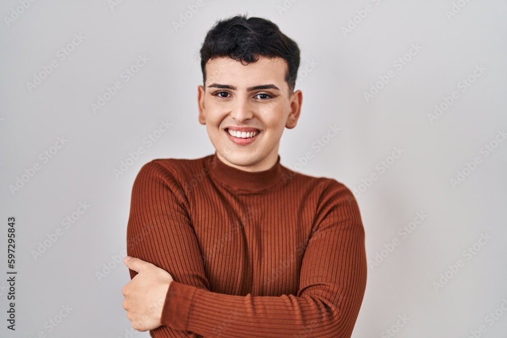 Non binary person wearing make up standing over isolated background happy face smiling with crossed arms looking at the camera. positive person. Non binary person wearing make up standing over isolated background happy face smiling with crossed arms looking at the camera. positive person.