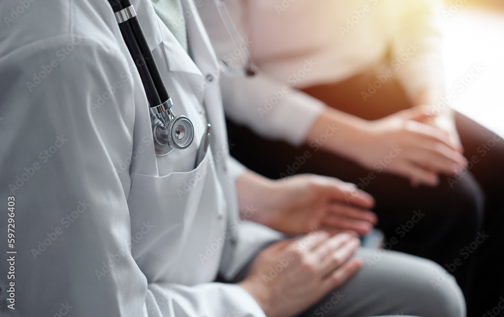 Doctor and patient discussing current health examination while sitting at the desk in clinic office, closeup. Medicine concept. Doctor and patient discussing current health examination while sitting at the desk in clinic office, closeup. Medicine concept.