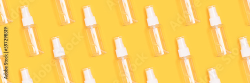 Banner with pattern made of empty spray bottle on a yellow background.