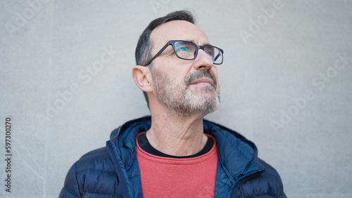 Middle age man looking to the sky at street