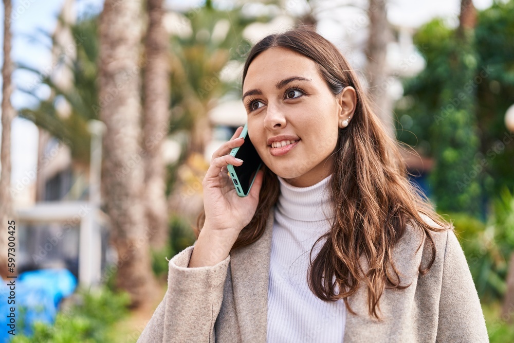 Young beautiful hispanic woman smiling confident talking on the smartphone at park Young beautiful hispanic woman smiling confident talking on the smartphone at park