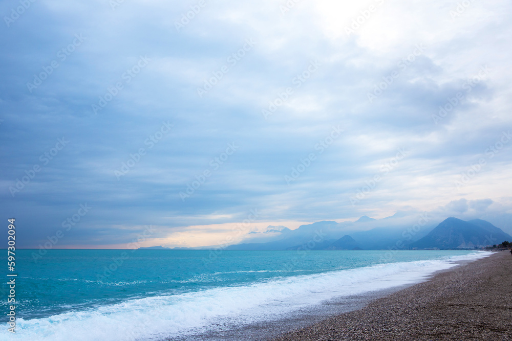 Storm in the Mediterranean Sea. Beautiful rocky shore with rolling waves. Turkiye, Antalya.