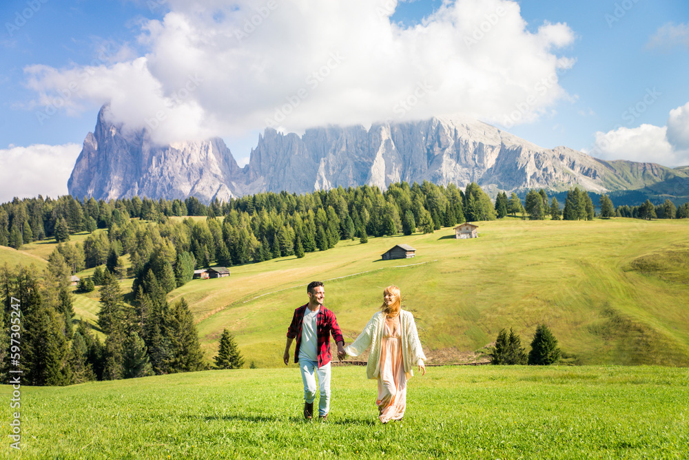 Couple of tourists enjoying a trip in the nature- Beautiful happy couple having fun during an excursion at dolomites mountains